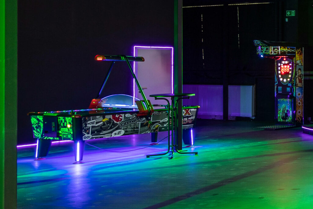 Air-Hockey-Tisch mit Neonbeleuchtung in der Spielhalle.